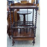 A mid Victorian rosewood Canterbury, the galleried upper tier over a spiralled, central section,