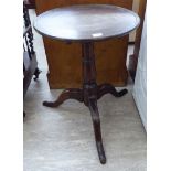 A George III stained oak tip-top pedestal table, raised on a ring turned,