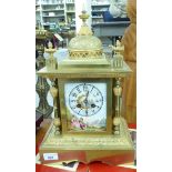 A late 19th/early 20thC lacquered brass cased mantel clock with a domed and finial top,