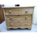 An early 20thC rustically constructed pine, three drawer dressing chest,