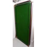 A Riley Terry Griffiths snooker table with a green baize lined surface (on wood) and raised on