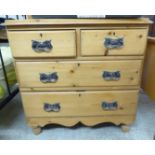 An early 20thC waxed pine four drawer dressing chest,