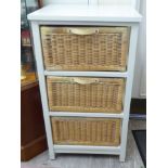 A modern cream painted bathroom unit with three woven cane drawers,