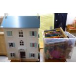 A modern painted wooden and plastic doll's house;