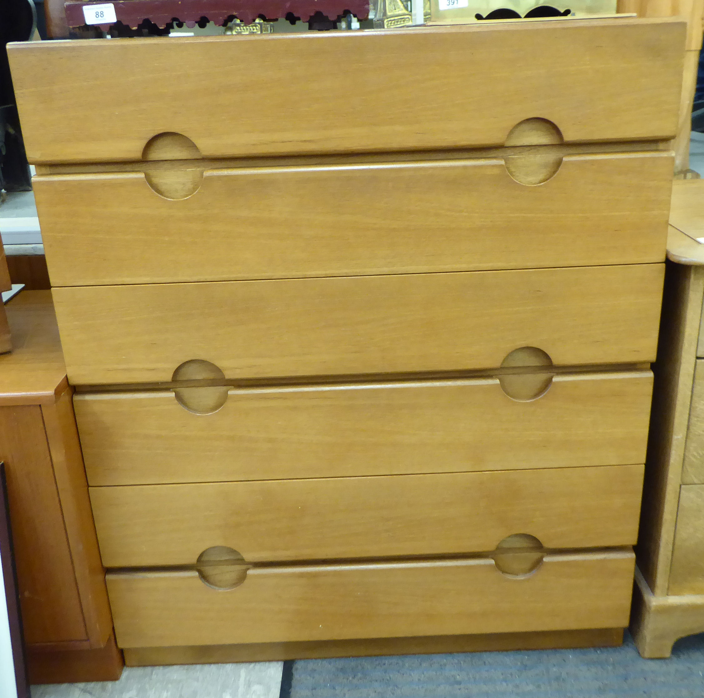 A G-Plan teak dressing chest with six graduated drawers, incorporating cut-out handles,