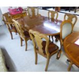 A mid 20thC walnut dining table, the figured top with a crossbanded border,