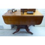 A Regency mahogany Pembroke table, raised on a rectangular column and splayed,