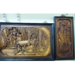 Two similar 20thC Oriental relief carved and framed wooden panels,