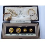A cased set of four 9ct gold shirt studs; a 9ct gold wedding ring; a signet ring; a floral brooch;
