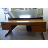 A G-Plan teak dressing table, the top surmounted by a mirror,