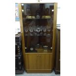 A modern teak display corner cabinet with a pair of glazed doors,
