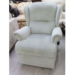 A modern Sherbourne speckled watered green upholstered wingback chair with electrically operated