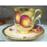 A Royal Worcester china coffee can and saucer, decorated with soft fruit and gilding,