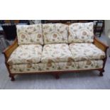 A 20thC mahogany showwood framed three person bergere settee, raised on stubby cabriole legs,
