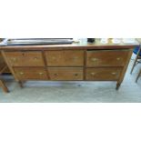 A late 19th/early 20thC honey coloured waxed pine farmhouse dresser, comprising six equal,