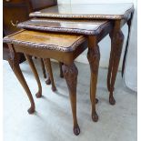 A nesting set of three burr walnut and mahogany finished occasional tables,