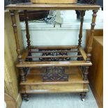 A late Victorian what-not Canterbury with a low fret carved galleried upstand,