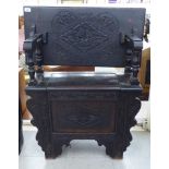 A late 19thC oak monks bench, the hinged top over a box seat, raised on carved,