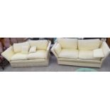 A pair of yellow patterned fabric upholstered, three person Knoll settees,