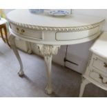 A modern cream coloured painted console table, raised on four cabriole legs,