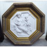 A modern composition marble effect plaque of octagonal form, depicting a mother and child,