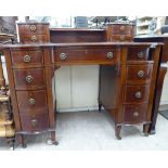 An Edwardian satinwood string inlaid mahogany nine drawer desk,