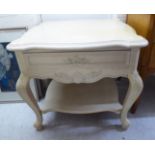 A modern cream painted French inspired lamp table, the serpentine outlined top,