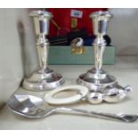 A pair of modern bead bordered, loaded silver dwarf candlesticks 4.