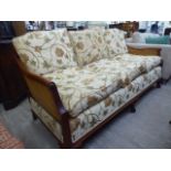 A 20thC mahogany showwood framed three person bergere settee, raised on stubby cabriole legs,