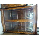 A modern mahogany cabinet bookcase with a pair of glazed doors,