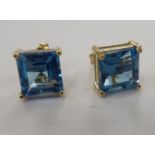 A pair of 9ct gold claw set blue topaz stud earrings 11