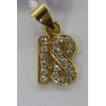 An 18ct gold and diamond set figure 18 pendant 11