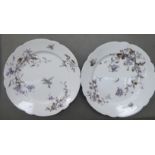 A pair of early 20thC German ivory glazed, porcelain, wavy edged plates,