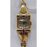 A lady's Rolls 9ct gold cased, red stone and diamond set bracelet wristwatch,