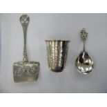 An Indian silver coloured metal caddy spoon,