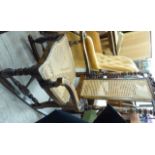 An early 20thC stained beech open arm rocking chair with a caned back and seat,