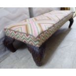 An early 20thC long, low rectangular stool,