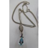 An 18ct white gold fine neckchain with a claw set aquamarine and diamond pendant,