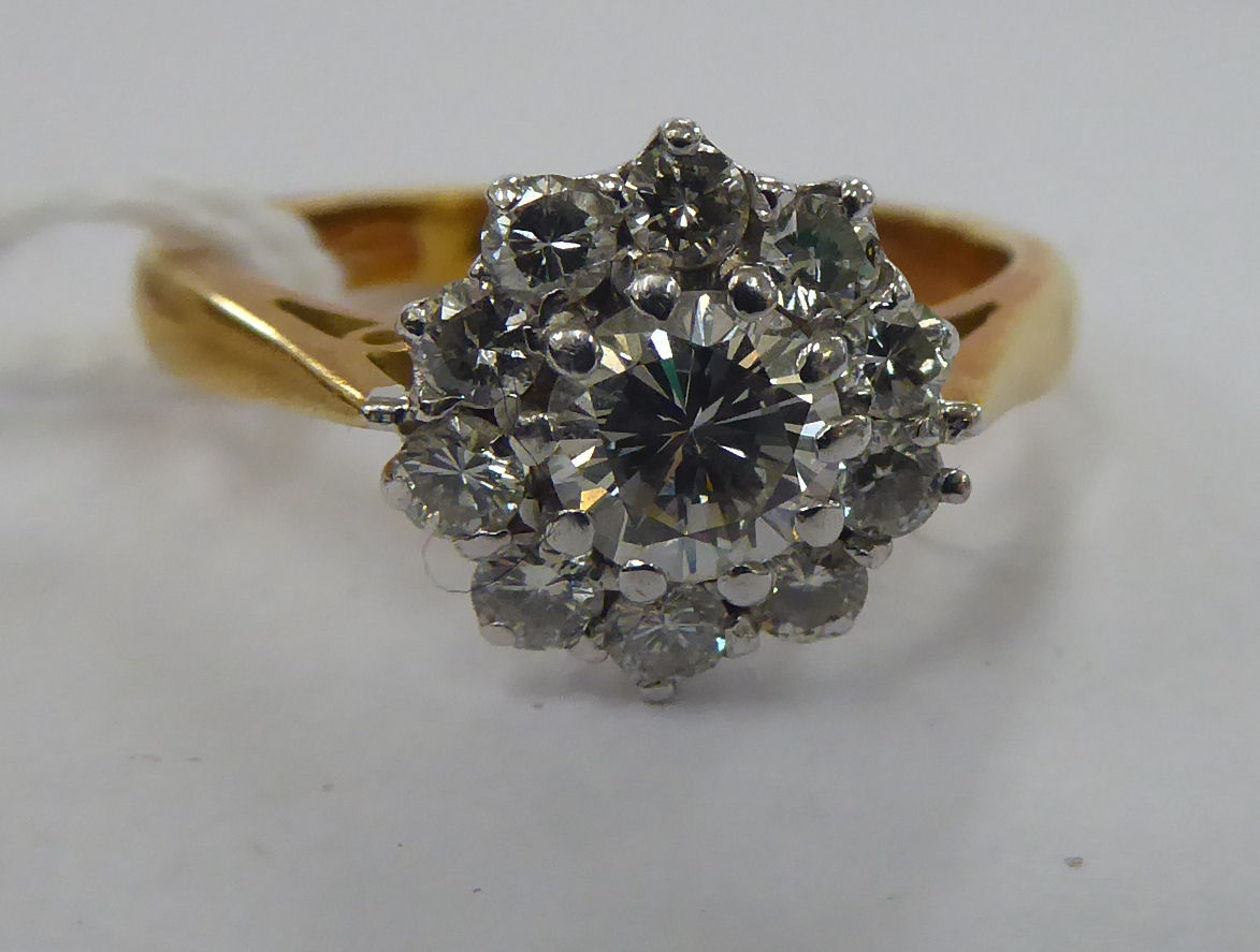 An 18ct gold claw set diamond cluster ring 11