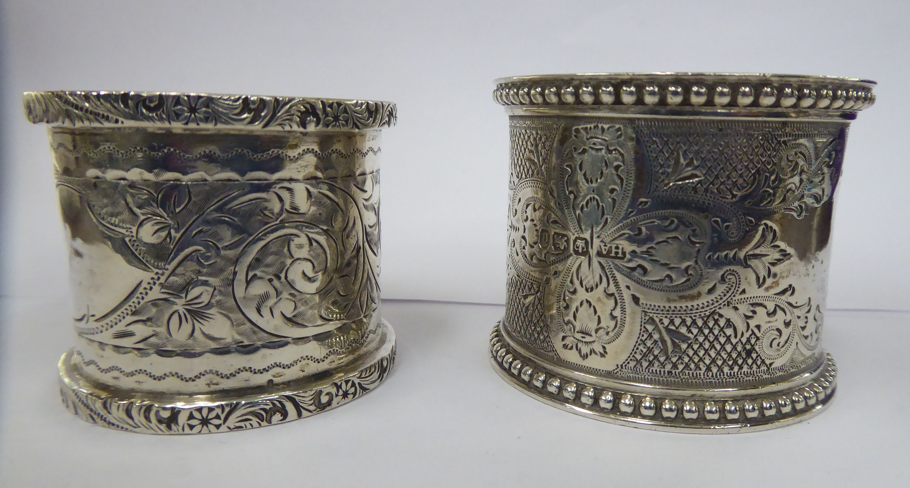 Two similar silver napkin rings with engine turned decoration Sheffield 1896 & Birmingham 1910