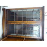 A modern mahogany cabinet bookcase with a pair of glazed doors,