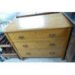 An early/mid 20thC light oak three drawer dressing chest,