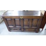 A late 18th/early 19thC panelled oak coffer, having straight sides and a hinged lid,