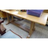 An early 20thC washed light oak refectory table,