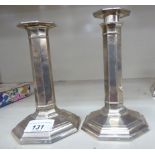 A pair of loaded silver candlesticks of octagonal form Sheffield 1912 6.
