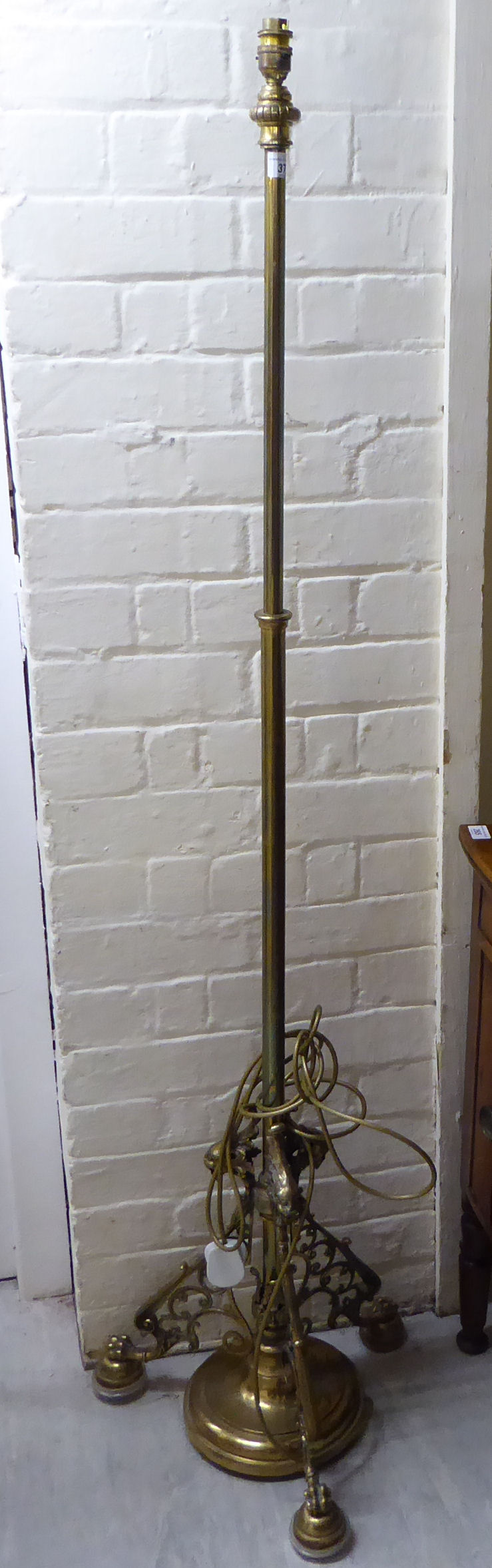 An 'antique' inspired cast and lacquered brass standard lamp,