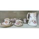 Hammersley china teaware, decorated with flora and misted gilding comprising a teapot, three cups,