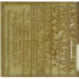 A mid 19thC sampler in cross stitch and other iron red coloured alphabet letters,