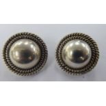 A pair of silver clip-on earrings 11