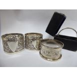 Four variously decorated silver napkin rings mixed marks OS10
